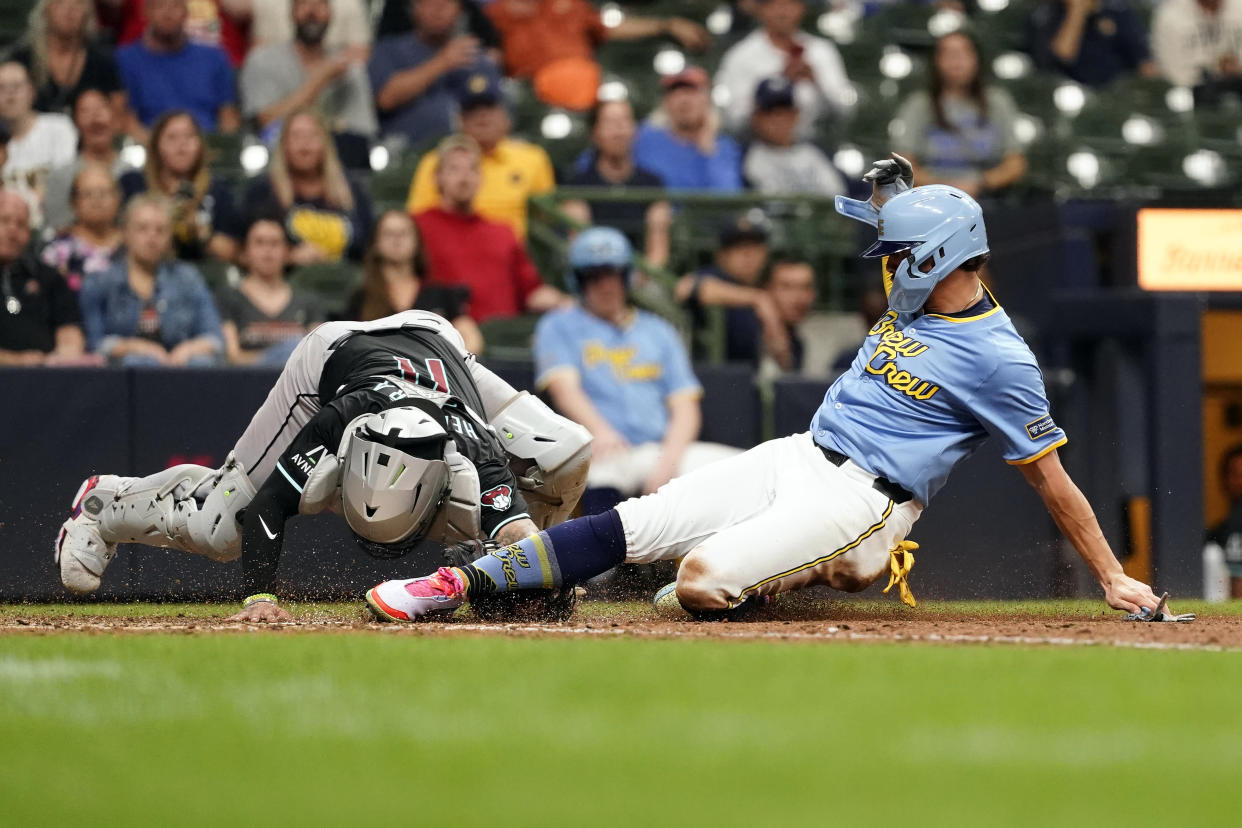 Milwaukee Brewers' Willy Adames, right, is tagged out at home by Arizona Diamondbacks' Jose Herrera during the seventh inning of a baseball game Sunday, Sept. 22, 2024, in Milwaukee. (AP Photo/Aaron Gash)