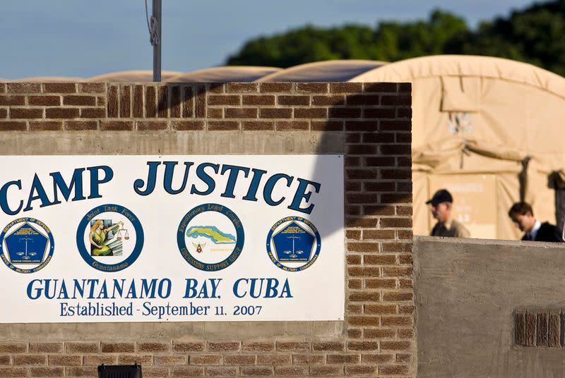 FILE PHOTO: In this image reviewed by the U.S. Military, members of a legal defence team walk at a U.S. military war crimes court at Guantanamo Bay U.S. Naval Base in Cuba