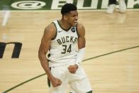 Milwaukee Bucks' Giannis Antetokounmpo reacts after teammate Khris Middleton made a three-point basket during the second half of Game 4 of the NBA Eastern Conference basketball semifinals game against the Brooklyn Nets Sunday, June 13, 2021, in Milwaukee. (AP Photo/Morry Gash)