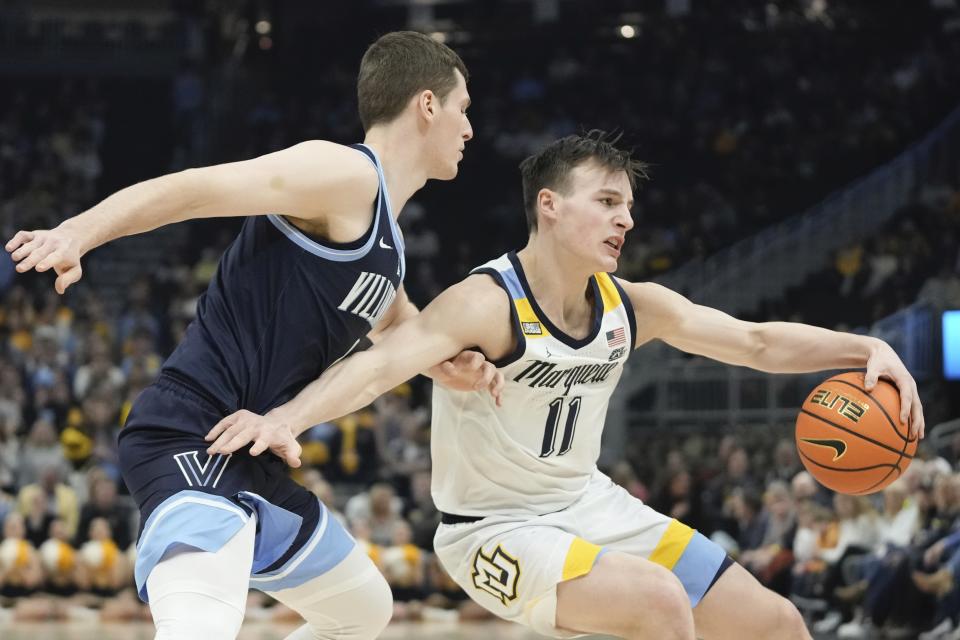 Marquette's Tyler Kolek looks to pass around Villanova's Chris Arcidiacono during the first half of an NCAA college basketball game Wednesday, Feb. 1, 2023, in Milwaukee. (AP Photo/Morry Gash)