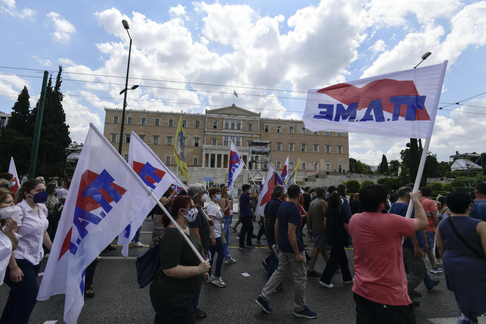 Supporters of the Greek communist party-affiliated PAME labor union march in front of the parliament, in Athens, Thursday, June 10, 2021. Widespread strikes in Greece brought public transport and other services to a halt Thursday, as the country's largest labor unions protested against employment reforms they argue will make flexible workplace changes introduced during the pandemic more permanent. (AP Photo/Michael Varaklas)