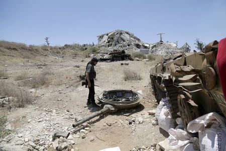 A rebel fighter from the Ahrar al-Sham Islamic Movement inspects a military post used by forces loyal to Syria's President Bashar al-Assad in Jabal al-Arbaeen, after the rebels said that they took control of the area, in Idlib countryside May 26, 2015. REUTERS/Khalil Ashawi