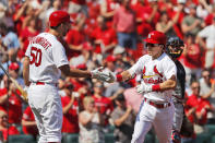 St. Louis Cardinals' Tommy Edman, right, is congratulated by teammate Adam Wainwright (50) after hitting a solo home run during the third inning of a baseball game against the Washington Nationals Wednesday, Sept. 18, 2019, in St. Louis. (AP Photo/Jeff Roberson)