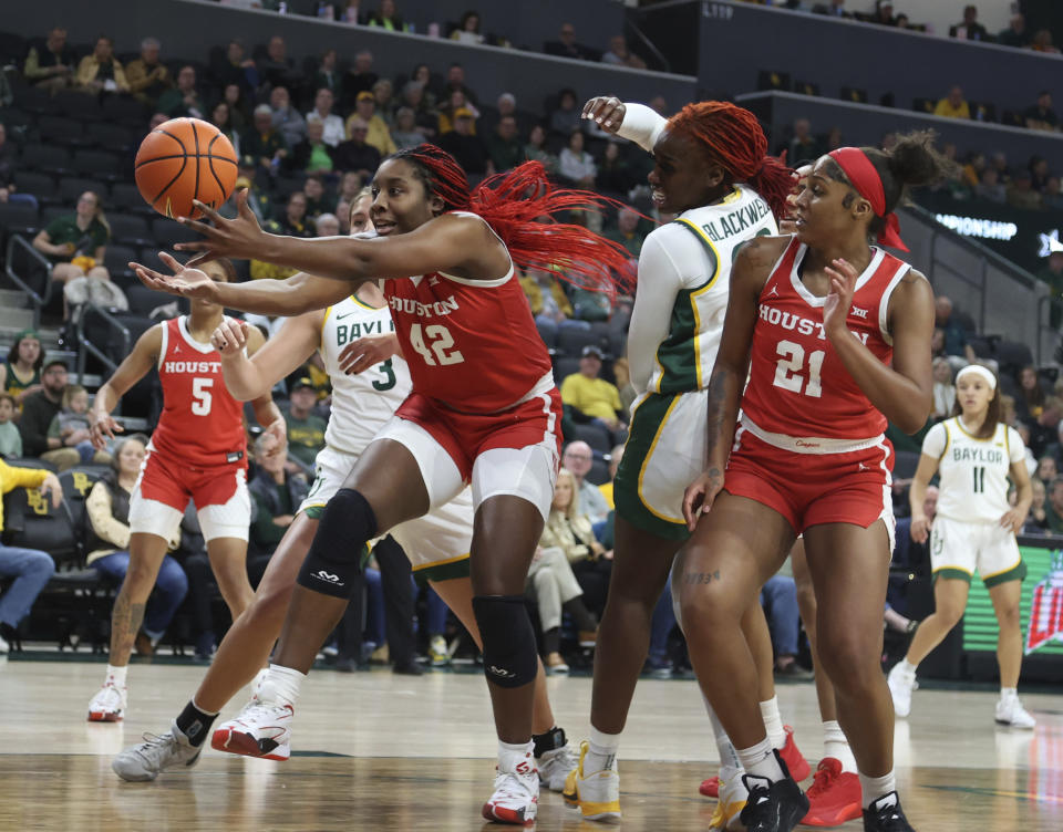 Houston forward Peyton McFarland pulls in a rebound over Baylor guard Aijha Blackwell in the first half of an NCAA college basketball game, Saturday, Jan. 6, 2024, in Waco, Texas. (Rod Aydelotte/Waco Tribune-Herald via AP)