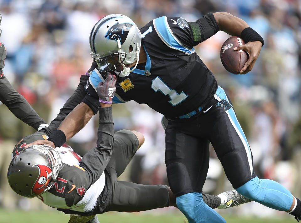 <p>Tampa Bay Buccaneers’ Justin Evans (21) grabs the face mask of Carolina Panthers’ Cam Newton (1) in the first half of an NFL football game in Charlotte, N.C., Sunday, Nov. 4, 2018. (AP Photo/Mike McCarn) </p>