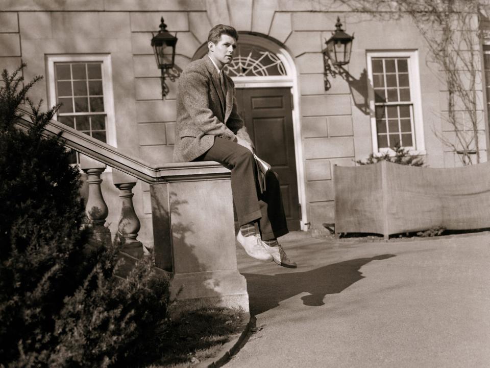 Joseph P. Kennedy Jr. sitting outside a building at Harvard University in 1938.