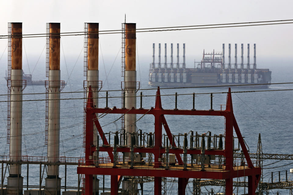 FILE - In this July 16, 2018, file photo, shows the Karadeniz Powership Orhan Bey is docked as a second floating power station waits off the coast at Jiyeh, south of Beirut, Lebanon. The company Karpowership that operates the facility said Friday it has shut down it has suspended its operations, a move expected to increase outages in the crisis-hit Mediterranean country. (AP Photo/Bilal Hussein, File)