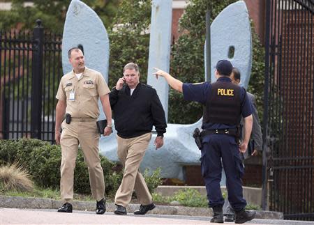 Naval officers are directed by police as they leave the Washington Naval Yard after a shooting in Washington September 16, 2013. REUTERS/Joshua Roberts