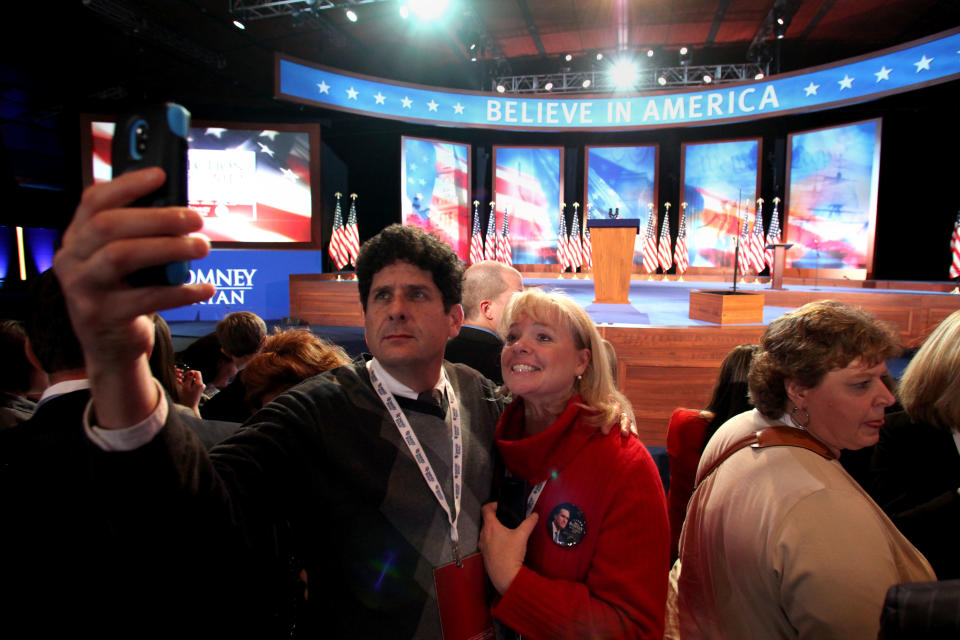 A man takes a photo with a smartphone in front of the stage during Mitt Romney's campaign election night event at the Boston Convention & Exhibition Center on November 6, 2012 in Boston, Massachusetts. Voters went to polls in the heavily contested presidential race between incumbent U.S. President Barack Obama and Republican challenger Mitt Romney. (Photo by Matthew Cavanaugh/Getty Images)