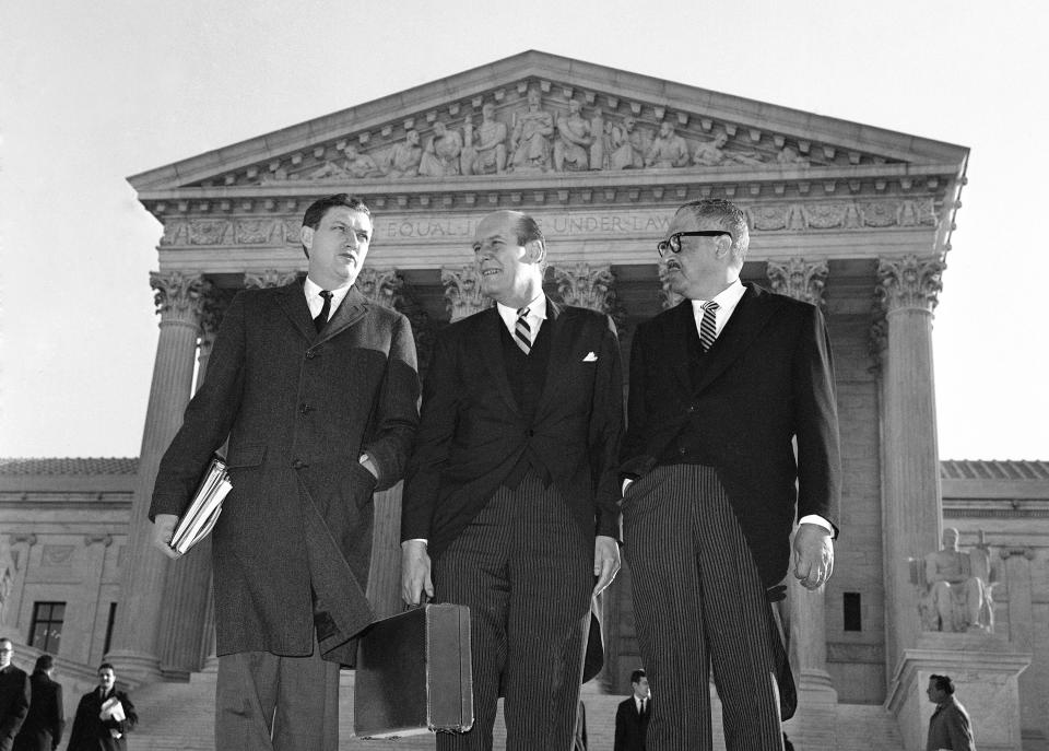 FILE - Assistant Attorney General John Doar, left, stands with Attorney General Nicholas Katzenbach, center, and Solicitor General Thurgood Marshall as they arrive at the Supreme Court in Washington to defend the legality of the 1965 Voting Rights Act on Jan. 17, 1966. (AP Photo)
