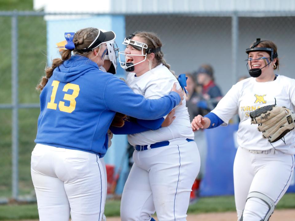 Cadence Puckett is congratulated by teammate Kate Foster after getting the final out of West Muskingum's 6-5 win against visiting Morgan on Monday in Falls Township. Puckett pitched a complete game and had the go-ahead RBI in the sixth inning as the Tornadoes took the outright lead in the Muskingum Valley League-Small School Division.