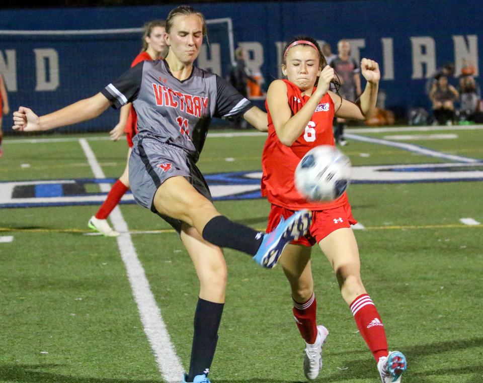 Victory Christian junior Kaycee Hunter clears the ball up the field in front of All Saints seventh-grader Kaya Carli on Monday afternoon in the semifinals of the Class 2A, District 7 girls soccer tournament at Lakeland Christian.