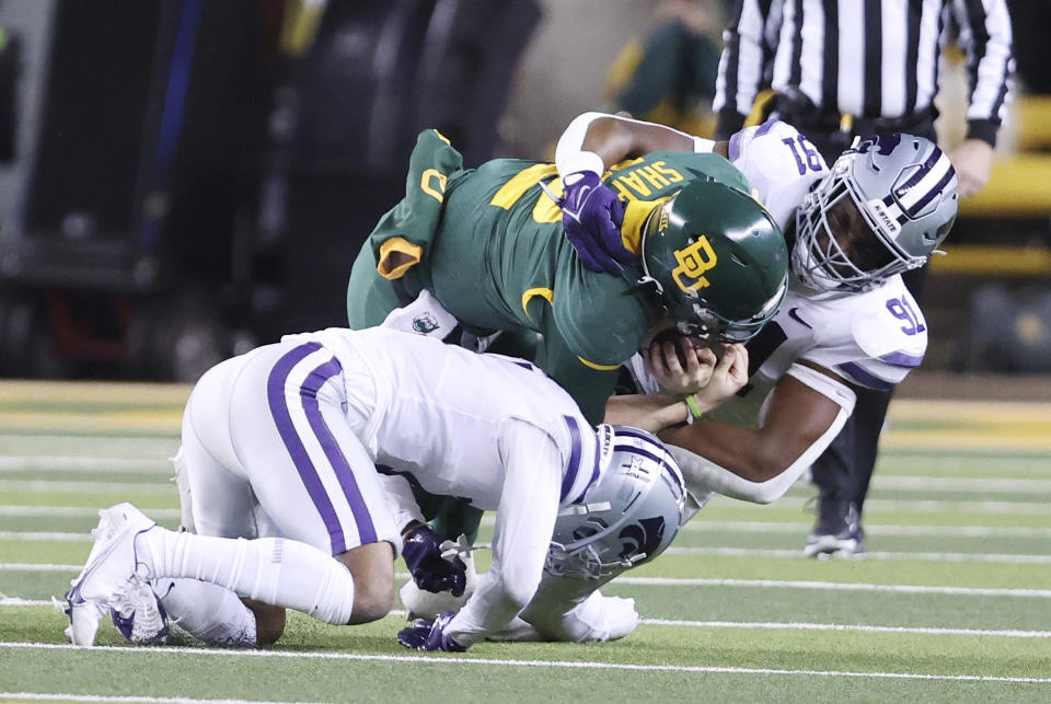 Baylor quarterback Blake Shapen is tackled by Kansas State defensive end Felix Anudike-Uzomah, right, and safety Josh Hayes, left, in the second half of an NCAA college football game, Saturday, Nov. 12, 2022, in Waco, Texas. (Rod Aydelotte/Waco Tribune-Herald via AP)