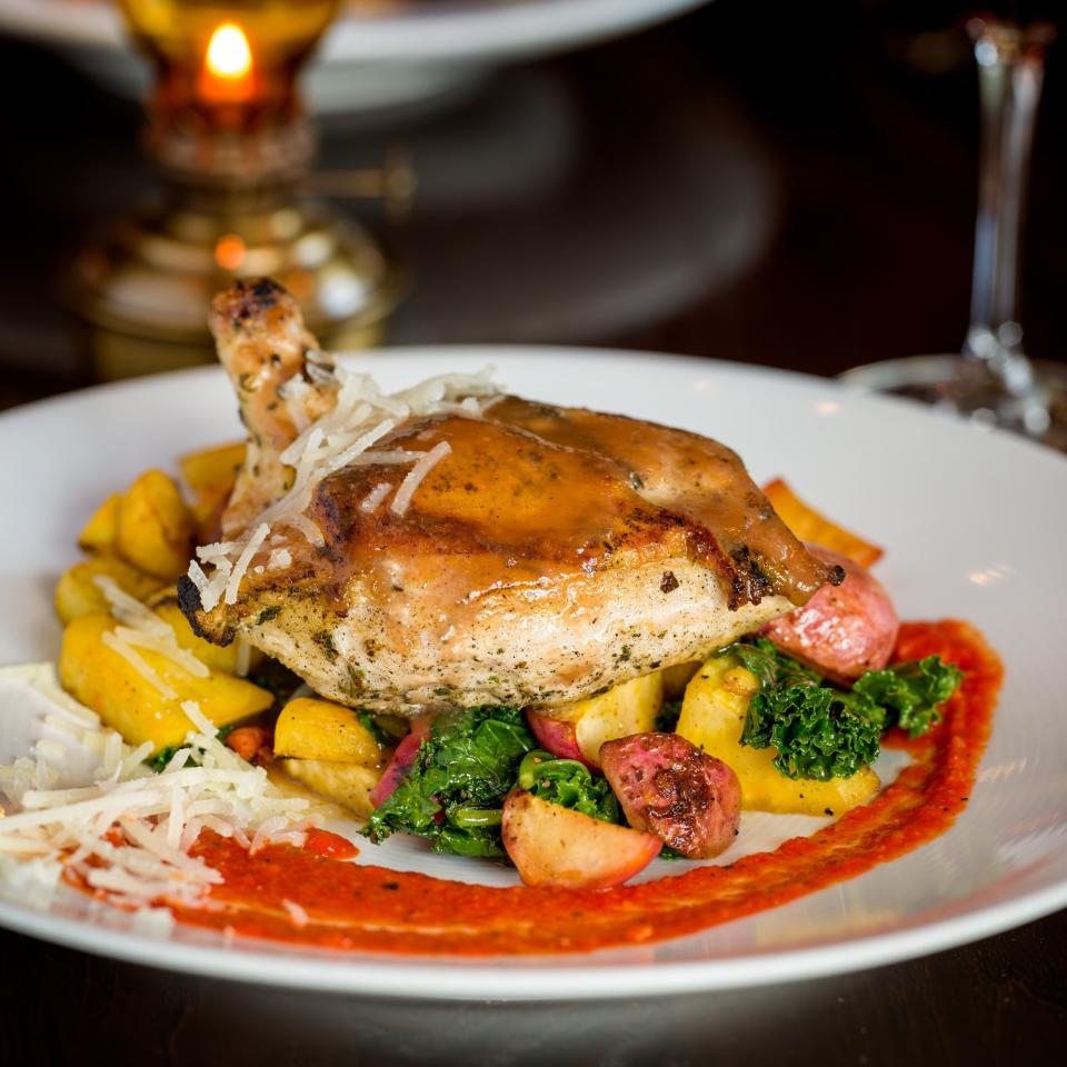 Posana's Joyce Farms Chicken entree with quince glazed Frenched chicken breast, kale, manchego, saffron roasted root vegetables and hazelnut piquillo romesco, available during the 2024 Asheville Restaurant Week.