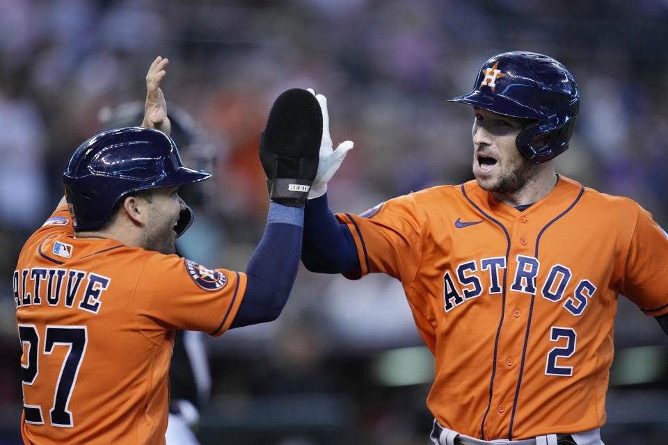 Houston Astros' Alex Bregman (2) celebrates his two-run home run with Astros' Jose Altuve, left, during the first inning of a baseball game against the Arizona Diamondbacks Sunday, Oct. 1, 2023, in Phoenix. (AP Photo/Ross D. Franklin)