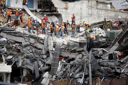 Members of rescue teams continue to search for people under the rubble of a collapsed building, after an earthquake, in Mexico City, Mexico September 23, 2017. REUTERS/Jose Luis Gonzalez