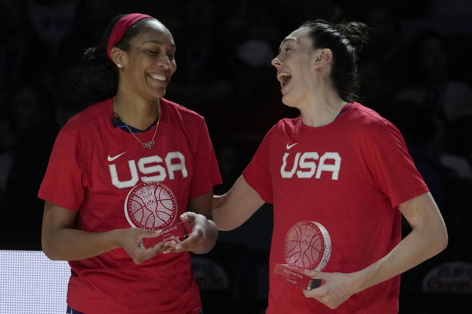 United States' A'ja Wilson, left, is congratulated by her teammate Breanna Stewart after Wilson was named most valuable player of the tournament after the gold medal game at the women's Basketball World Cup in Sydney, Australia, Saturday, Oct. 1, 2022. (AP Photo/Rick Rycroft)