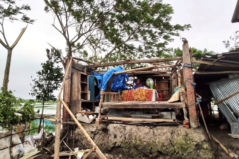 Woman is seen inside her damaged house after cyclone Bulbul hit the area in Khulna
