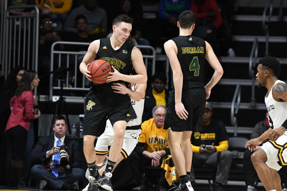 CATONSVILLE, MD - FEBRUARY 21:  Ernie Duncan #20 of the Vermont Catamounts dribbles around Robin Duncan #4 during a college basketball game against the UMBC Retrievers at the Event Center on February 21, 2019 in Catsonsville, Maryland.  (Photo by Mitchell Layton/Getty Images)
