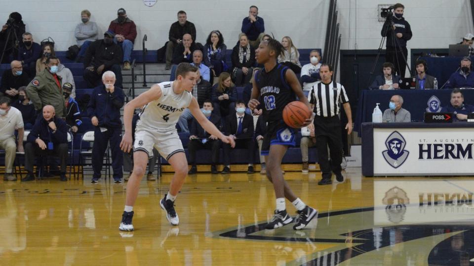 Jahir Walker of Wildwood Catholic (right) brings the ball up the court as Noah Plenn of St. Augustine defends during the first quarter of their Cape-Atlantic League game on Wednesday, January 26, 2022.