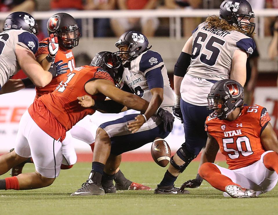 Utah State QB Chuckie Keeton loses the ball as he is hit by Utah defensive end Jason Fanaika Friday, Sept. 11, 2015, at Rice-Eccles Stadium in Salt Lake City. After a nine-year hiatus, the two programs will meet again in 2024 in Logan. | Scott G Winterton, Deseret News