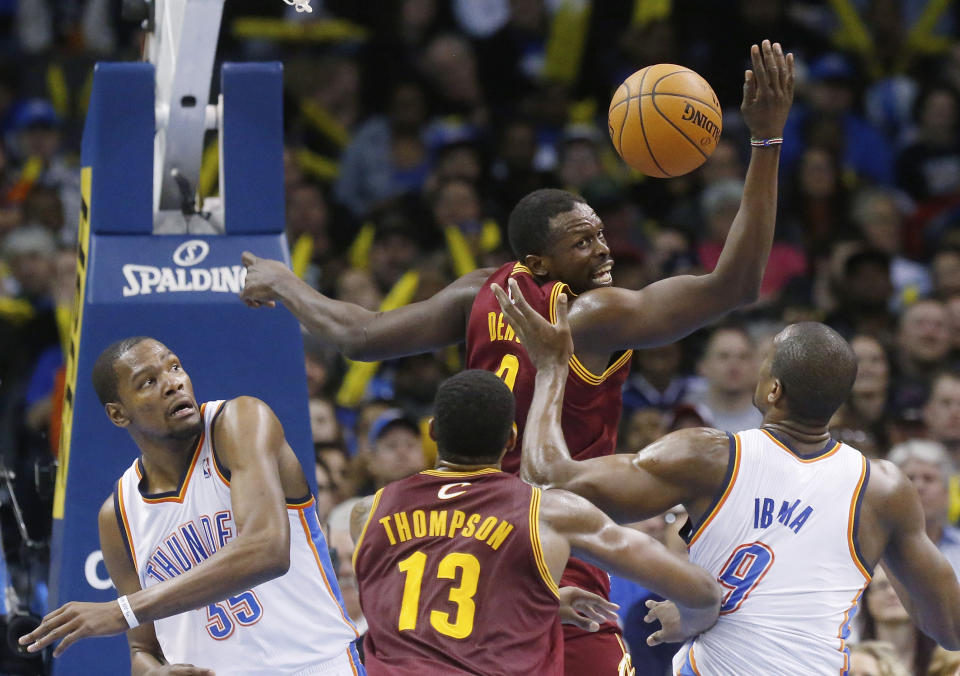 Cleveland Cavaliers forward Luol Deng (9) loses the ball after a foul by Oklahoma City Thunder forward Kevin Durant (35) during the fourth quarter of an NBA basketball game in Oklahoma City, Wednesday, Feb. 26, 2014. Cleveland won 114-104. (AP Photo/Sue Ogrocki)