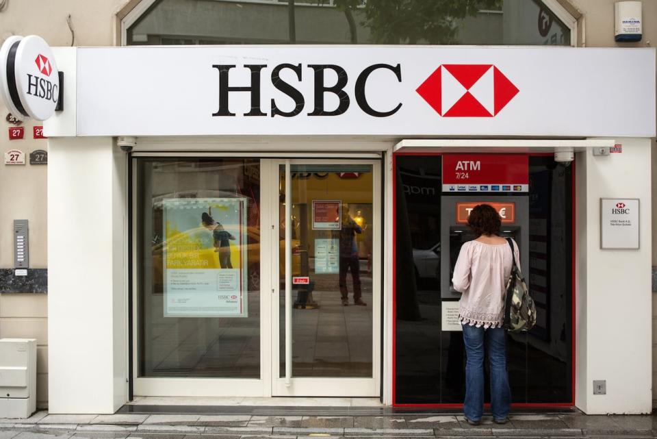 A customer uses an automated teller machine (ATM) outside an HSBC Holdings Plc bank. RBC is looking to buy HSBC for $13.5 billion. (Kerem Uzel/Bloomberg - image credit)