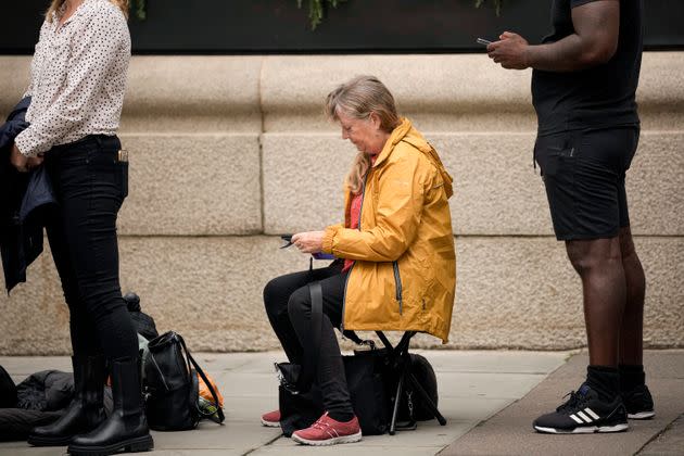 A woman sits as she waits to say farewell to Elizabeth on Wednesday. (Photo: via Associated Press)