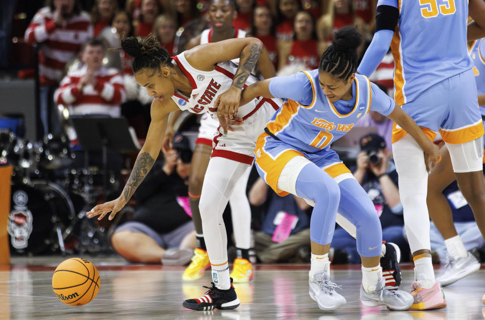 North Carolina State's Aziaha James, left, steals the ball from Tennessee's Jewel Spear (0) during the first half of a second-round college basketball game in the NCAA Tournament in Raleigh, N.C., Monday, March 25, 2024. (AP Photo/Ben McKeown)