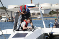 Technicians check the hull and interior of the Mayflower Autonomous Ship at its launch site for it's first outing on water since being built in Turnchapel, Plymouth south west England, Monday, Sept. 14, 2020. The ship aims to cross the Atlantic from Plymouth, England, to Plymouth, Ma, USA, in April 2021, to become be the first totally autonomous ship to cross the ocean without any help from the outside. (AP Photo/Alastair Grant)