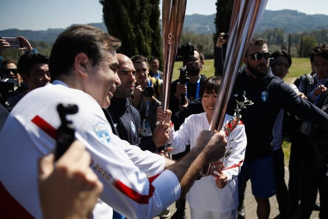 The torch of the Tokyo Olympics is passed along