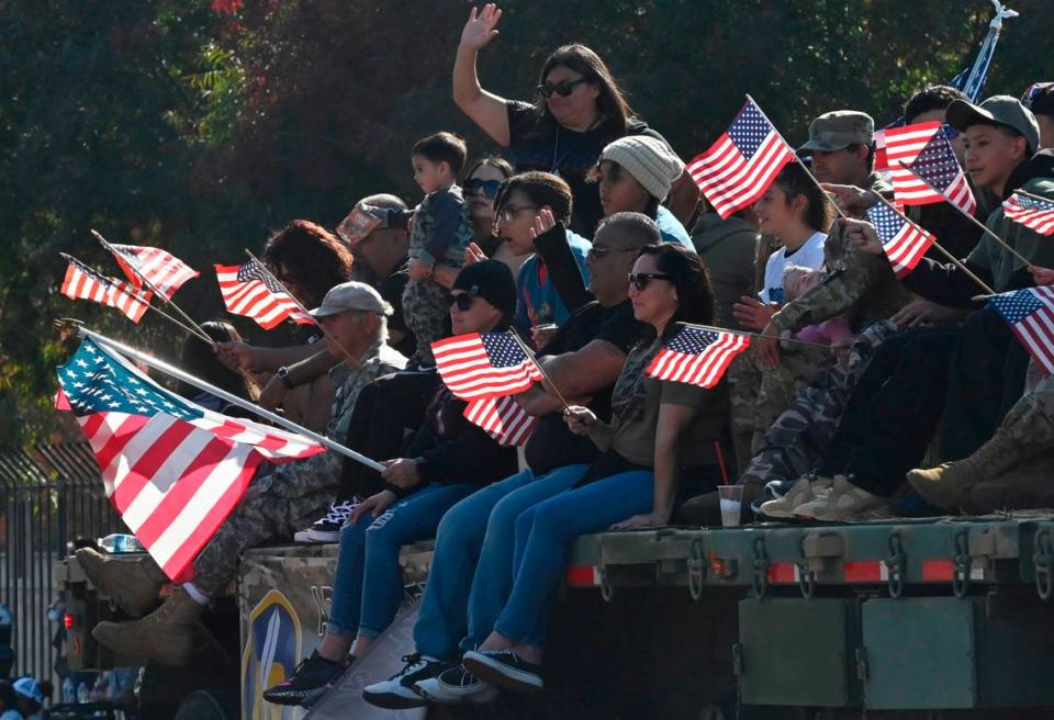 A flatbed truck carries representatives of the Army Reserve Career Group, 11th Battalion, Area 2 at the annual Central Valley Veterans Day Parade held Saturday, Nov. 11, 2023 in downtown Fresno.