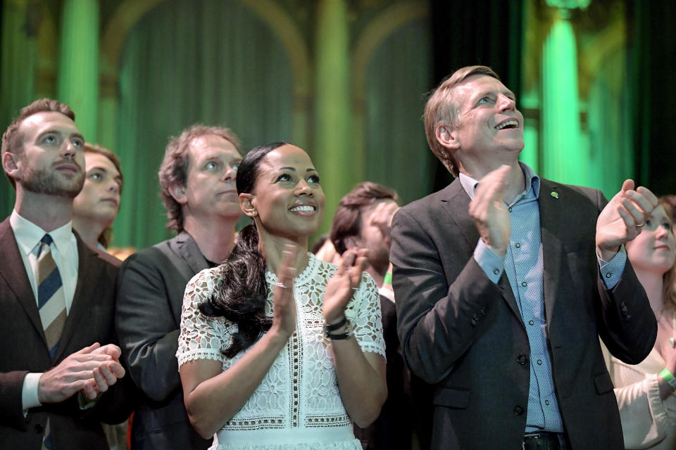 Swedish Green Party (Miljoepartiet) candidate Alice Bah Kuhnke, center, and Per Bolund, right, Minister for Financial Markets and Housing, applaud at the party's election night watch party as first preliminary results in the European Parliament elections are presented, at Clarion Hotell in Stockholm, Sweden, Sunday, May 26, 2019. (Janerik Henriksson/TT News Agency via AP)