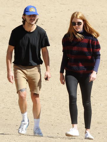 <p>WENN Rights Ltd / Alamy</p> Shia LaBeouf and Mia Goth out at a park with their bulldog Brando on October 15, 2016.