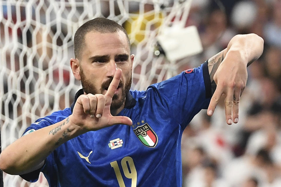 Italy's Leonardo Bonucci celebrates with this teammates after scoring his side's opening goal during the Euro 2020 soccer final match between England and Italy at Wembley stadium in London, Sunday, July 11, 2021. (Andy Rain/Pool Photo via AP)