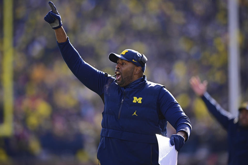 Michigan acting head coach Sherrone Moore reacts to a video replay during the first half of an NCAA college football game against Ohio State, Saturday, Nov. 25, 2023, in Ann Arbor, Michigan. (AP Photo/David Dermer)