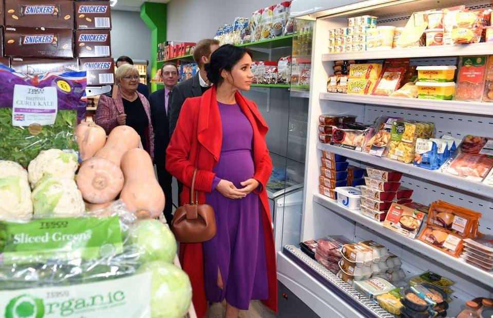 <p>During a tour of a recently opened village grocery store in Birkenhead, Meghan Markle took a peek at the store's refrigerated section. We're sure she was familiar with this aisle from her pre-royal days.</p>