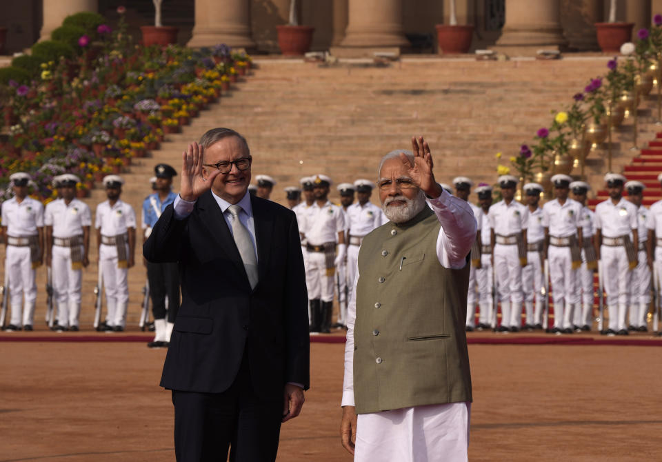 Indian Prime Minister Narendra Modi his Australian counterpart Anthony Albanese wave to media during laters's ceremonial reception at the Indian presidential palace, in New Delhi, India, Friday, March 10, 2023. Australia is striving to strengthen security cooperation with India and also deepen economic and cultural ties, Prime Minister Anthony Albanese said on Friday. (AP Photo/Manish Swarup)