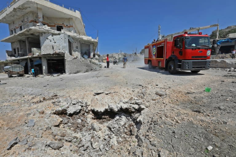 A picture taken on September 4, 2018 shows a fire engine driving on a damaged road after a reported Russian air strike in the rebel-hold town of Muhambal, about 30 kilometres southwest of the city of Idlib