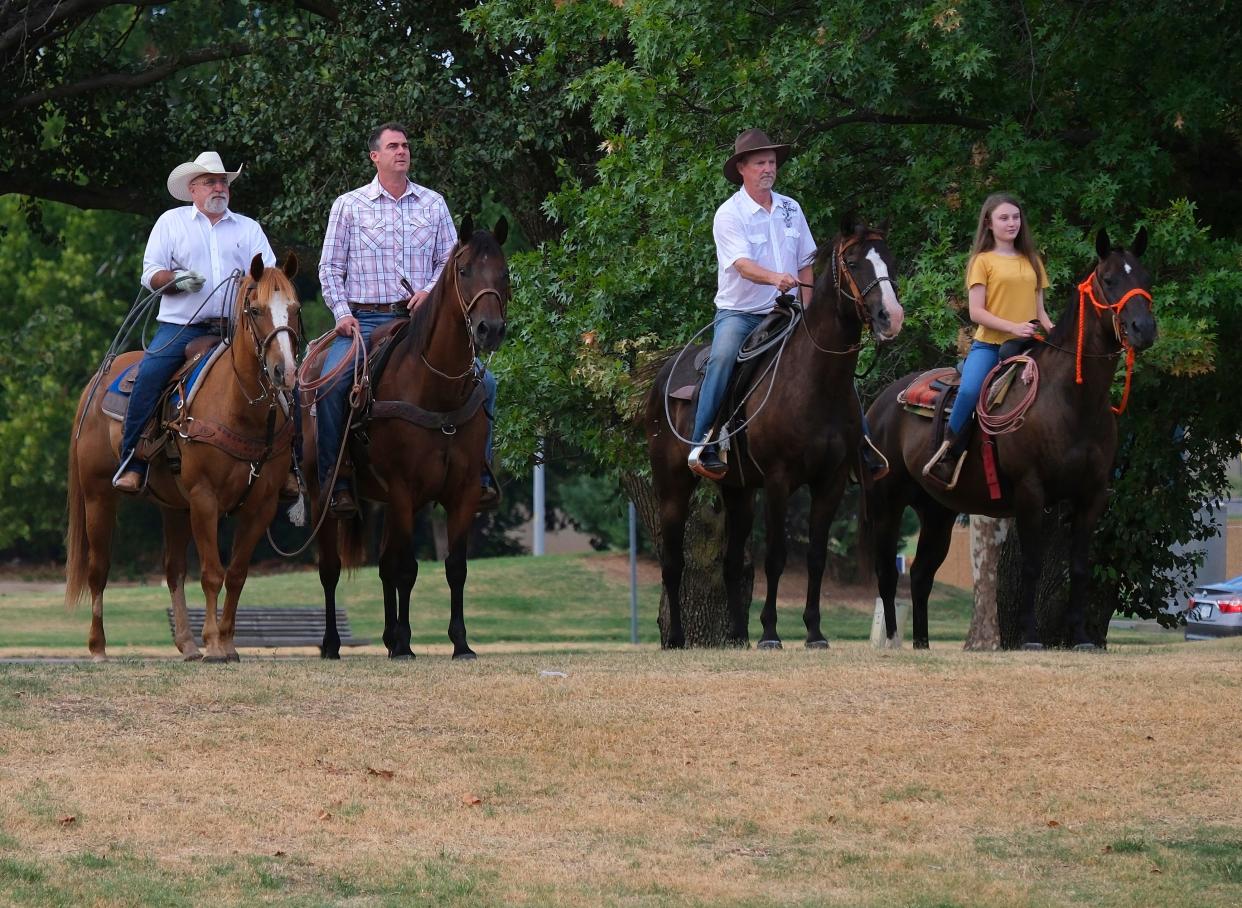 Sen. Blake "Cowboy" Stephens, at left, Gov. Kevin Stitt, Rep. Randy Randleman and his granddaughter, Julieanne Randleman, 11, rode horseback Aug. 10, 2022, as part of the ceremonial signing of House Bill 3261, which names the American Quarter Horse as the official state horse of Oklahoma.