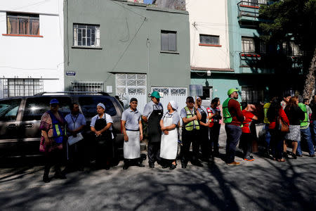 Workers are seen at a street following an earthquake in Mexico City, Mexico February 1, 2019. REUTERS/Carlos Jasso