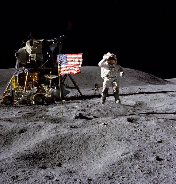 In this April 1972 photo made available by NASA, John Young salutes the U.S. flag at the Descartes landing site on the moon during the first Apollo 16 extravehicular activity. NASA says the astronaut, who walked on the moon and later commanded the first space shuttle flight, died on Friday, Jan. 5, 2018. He was 87. (Charles M. Duke Jr./NASA via AP)