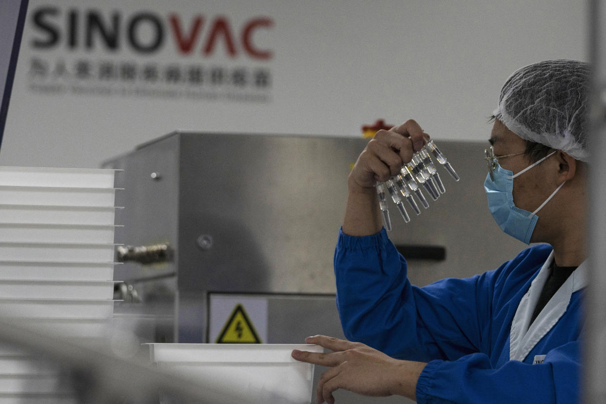 A worker inspects syringes of a vaccine for COVID-19 produced by Sinovac at its factory in Beijing on Thursday, Sept. 24, 2020. With rich countries snapping up supplies of COVID-19 vaccines, some parts of the world may have to rely on Chinese-developed shots to conquer the outbreak. The question: Will they work? (AP Photo/Ng Han Guan)