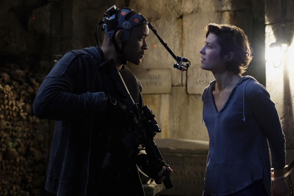 This image released by Paramount Pictures shows Will Smith, left, and Mary Elizabeth Winstead on the set of "Gemini Man." To create the character of Junior — a younger clone of Will Smith’s assassin Henry Brogan — Smith wore a head rig with two cameras capturing his facial expressions via tracking markers. (Ben Rothstein/Paramount Pictures via AP)