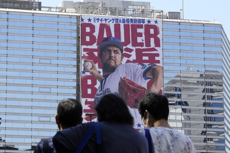 A giant banner of Trevor Bauer, who pitches for the Yokohama DeNA BayStars, is placed on a department store facade on Wednesday, May 3, 2023, in Yokohama near Tokyo. Bauer is pitching his first official game for the BayStars on Wednesday and, to promote the start, the local department store unveiled a seven-story poster of the former Cy Young winner on the building's facade. (AP Photo/Eugene Hoshiko)
