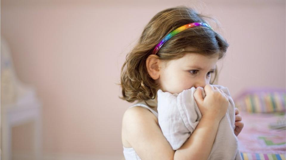 Young girl holding a cuddly toy