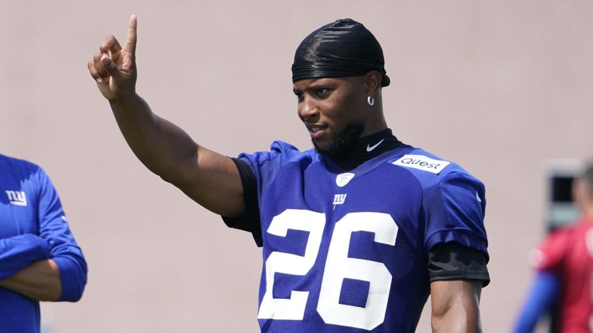 New York Giants running back Saquon Barkley (26) signs autographs