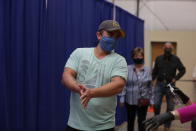 Democratic primary voter Sergio Marquez, 34, spreads sanitizing gel on his hands as he reenters a polling place to vote for congressional candidate Joseph Salazar in the primary, Tuesday, June 2, 2020, in Santa Fe, New Mexico. Marquez said an absentee ballot he requested never came and that a server issue at the polling place delayed him from voting in person. The problem was resolved within an hour and he was able to vote. (AP Photo/Cedar Attanasio)