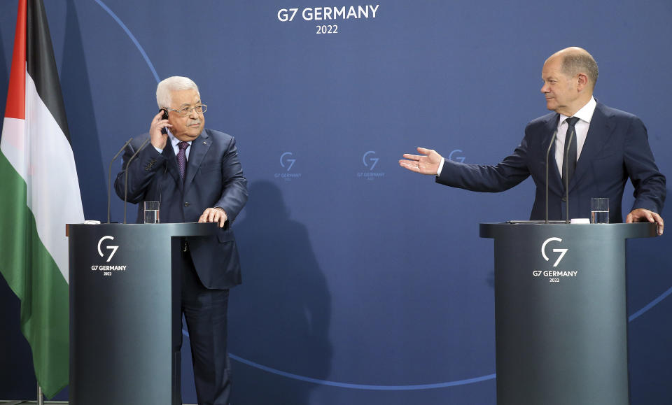 German Chancellor Olaf Scholz, right, and Mahmoud Abbas, President of the Palestinian Authority, answer questions from journalists at a press conference after their talks in Berlin, Germany, Tuesday, Aug.16, 2022. (Wolfgang Kumm/dpa via AP)