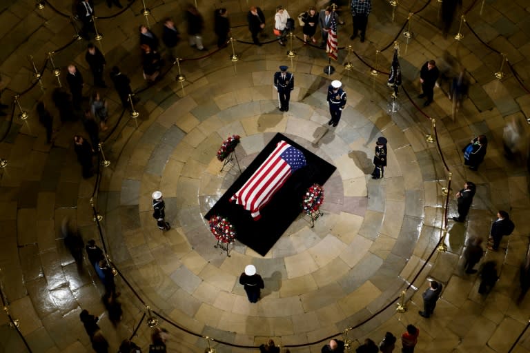 People pay their respects as the remains of former US President George H. W. Bush lie in state in the US Capitol